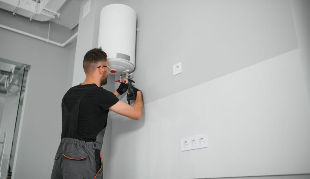 Heating engineer performing annual boiler maintenance